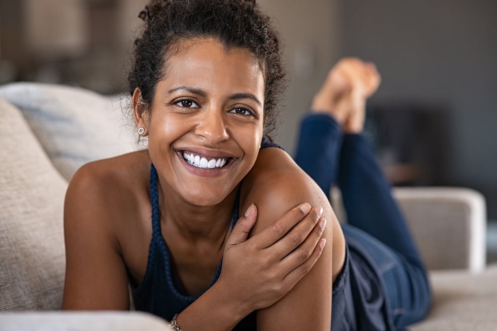 Happy Woman Lying on Couch 